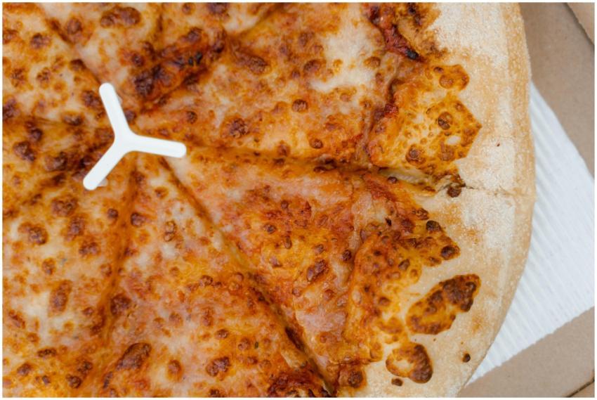 Delicious cheesy pizza in a cardboard box, perfect