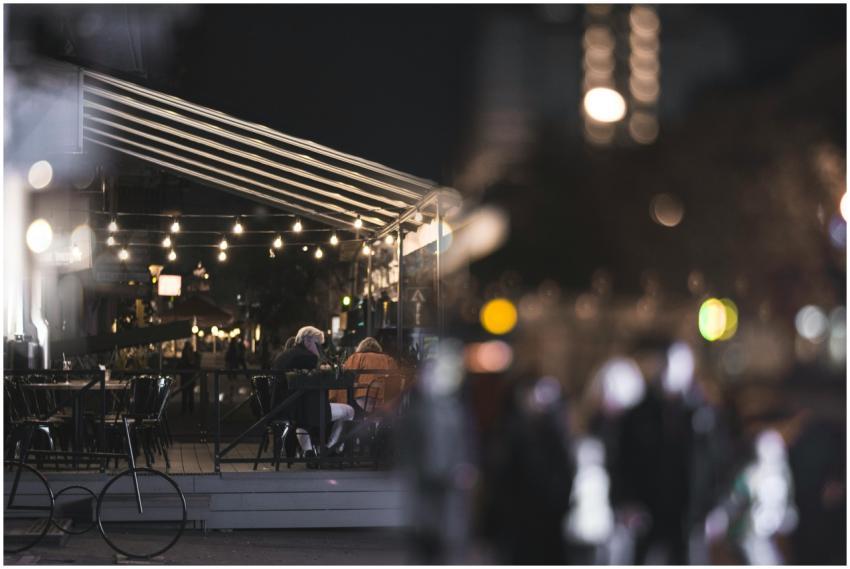 A cozy street cafe in Kyiv illuminated by ambient