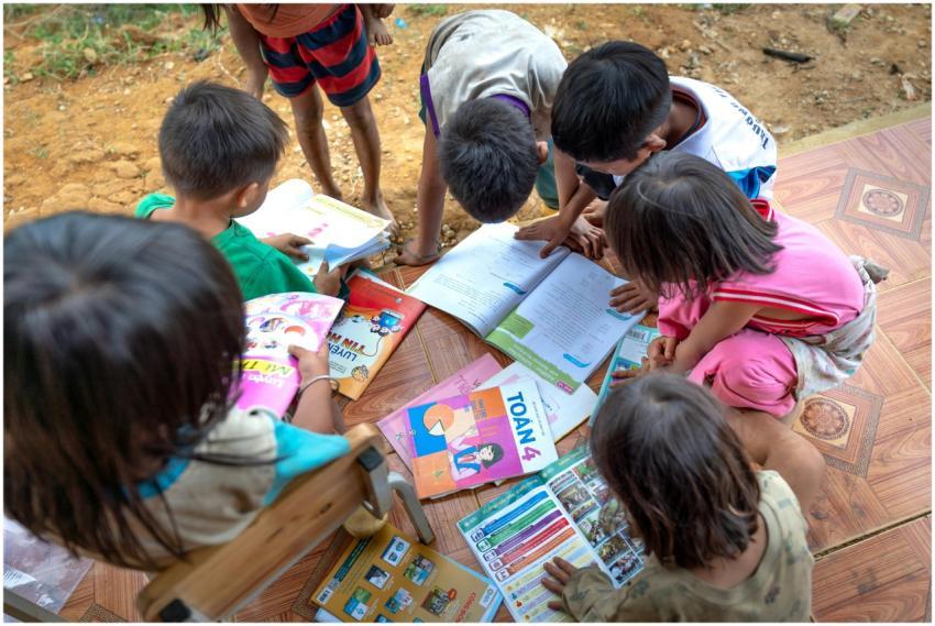 Children gathered outdoors, actively engaged in re