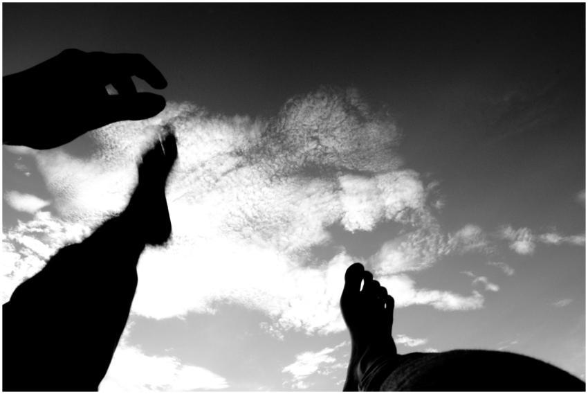 Dramatic black and white silhouette of feet and ha