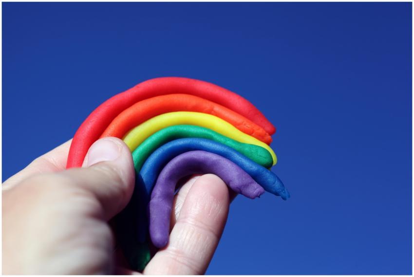 Creative play with rainbow-colored clay held again