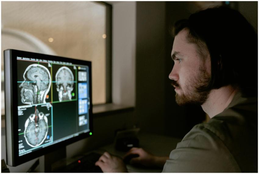 Radiologist examining a CT scan on a monitor in a