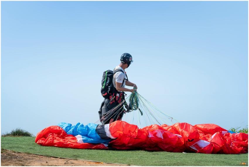 A person with gear prepares their parachute for pa