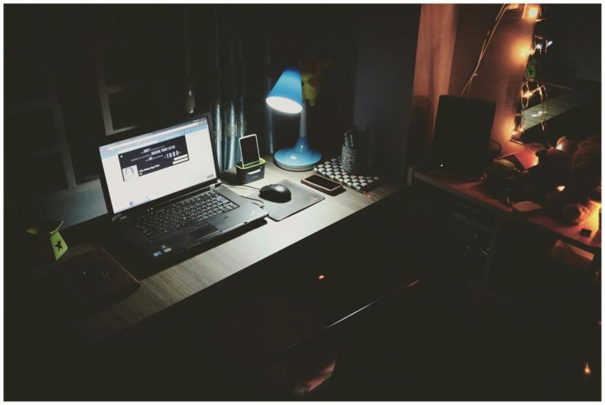 A well-lit desk with a laptop and modern accessori