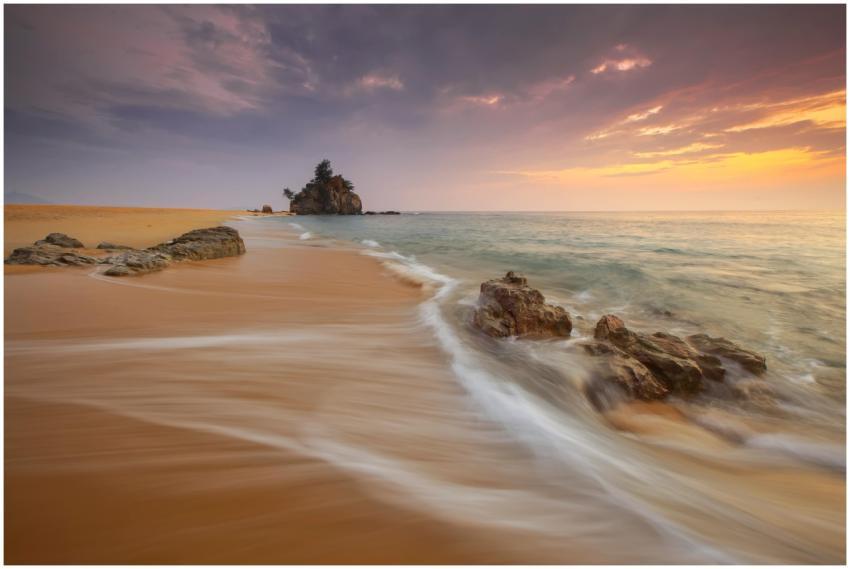 Tranquil beach scene at sunrise with soft waves an