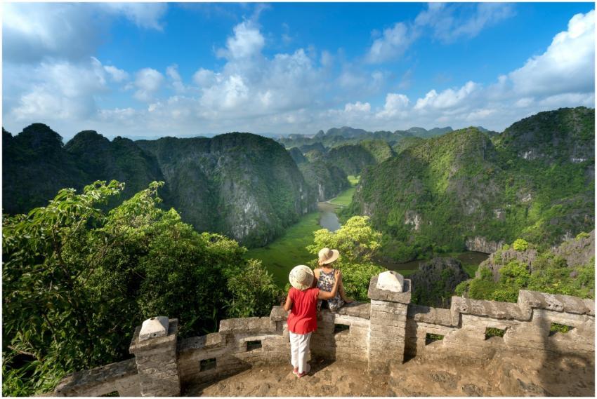 Tourists enjoy a stunning view of lush green mount
