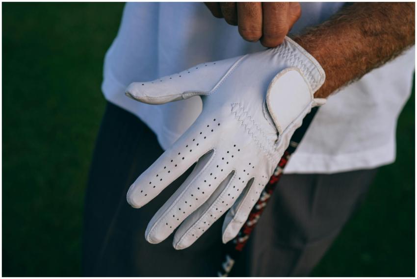 Close-up of a golfer adjusting their white glove w