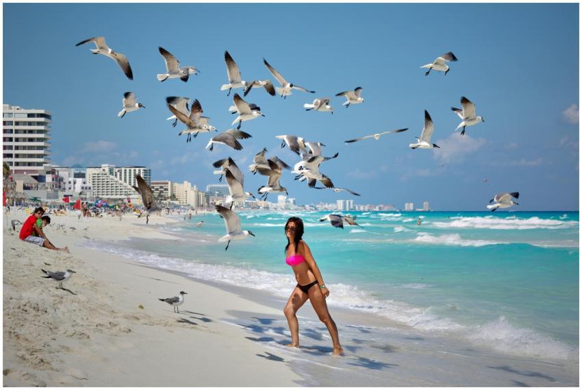 Woman on Cancun beach enjoying the summer surround