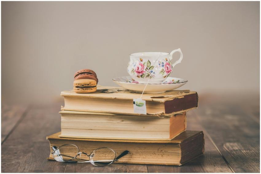 Elegant setup of floral teacup with macarons on a