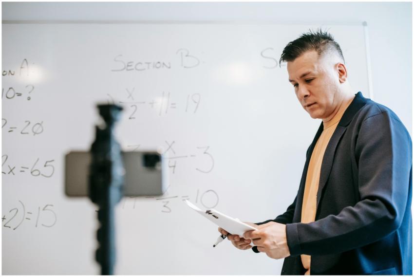 Educator teaching online math class, using whitebo