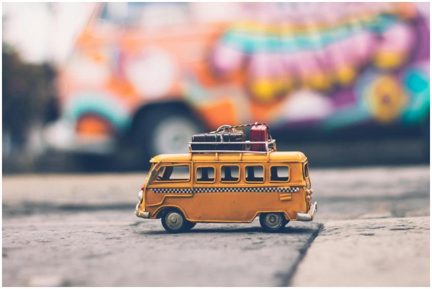 Close-up of a toy Volkswagen van with luggage, set