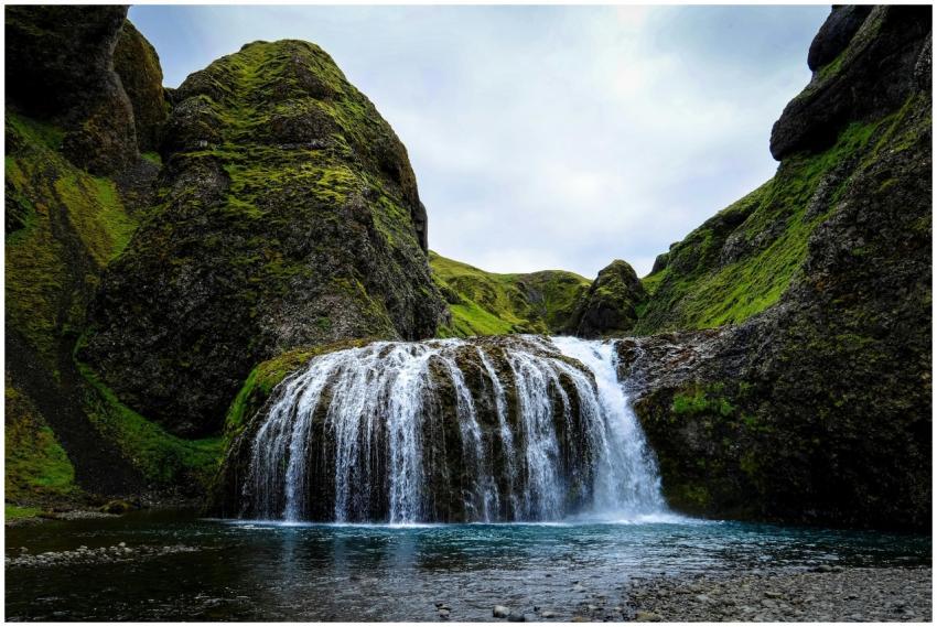 A beautiful waterfall cascading over moss-covered