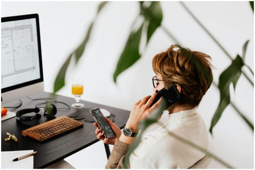 Side view of a woman multitasking in a modern offi