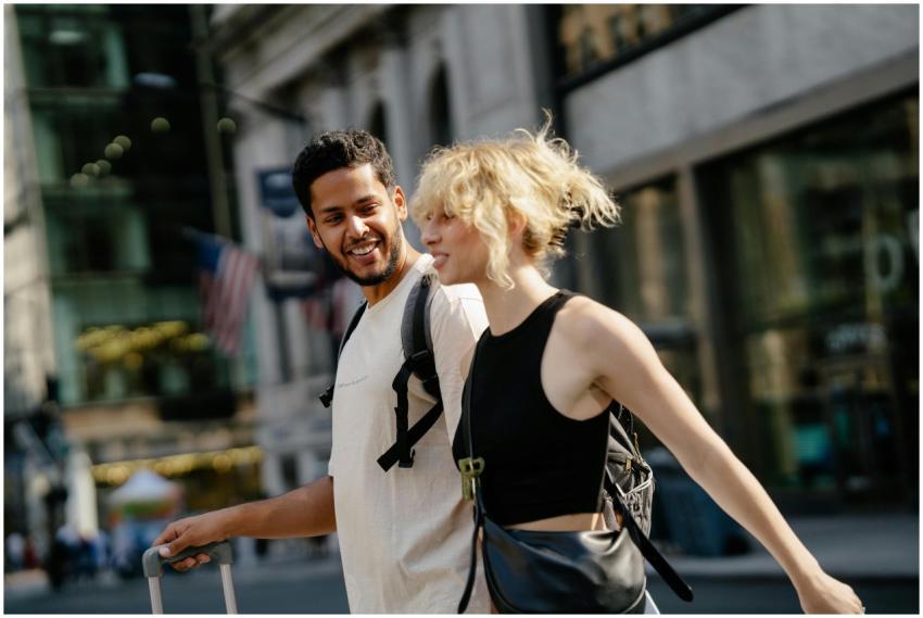 A man and a woman joyfully strolling through urban