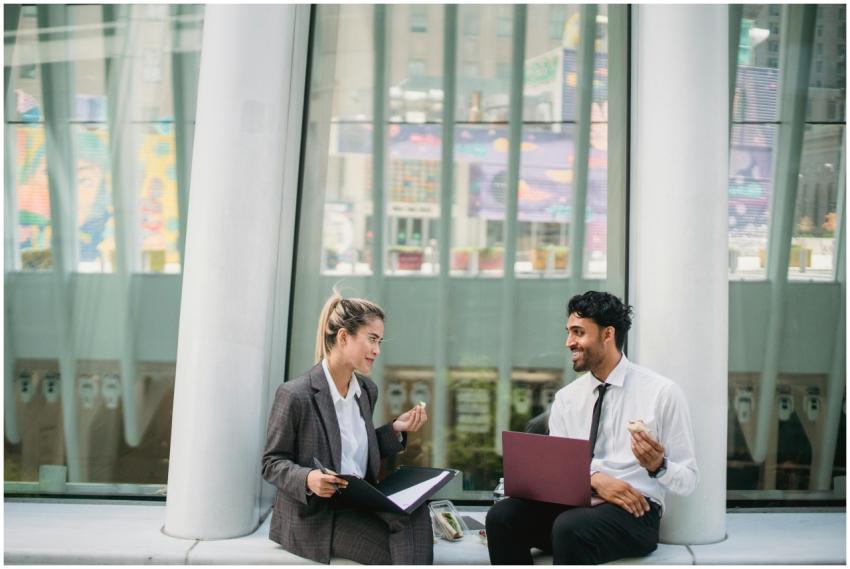 Two professionals share a casual snack meeting out