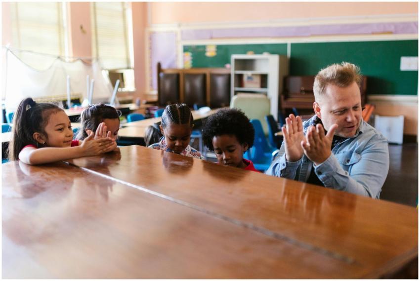 Children clap along with their teacher during an i
