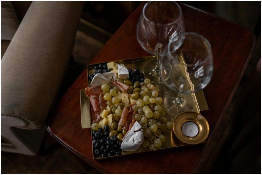 Elegant cheese platter with grapes, cold cuts, and