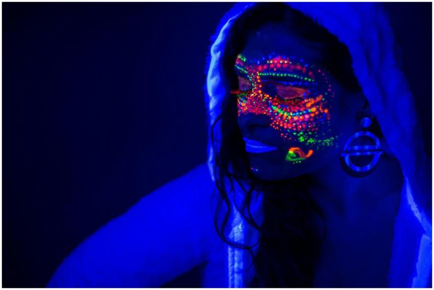 Portrait of a woman with glowing neon paint under