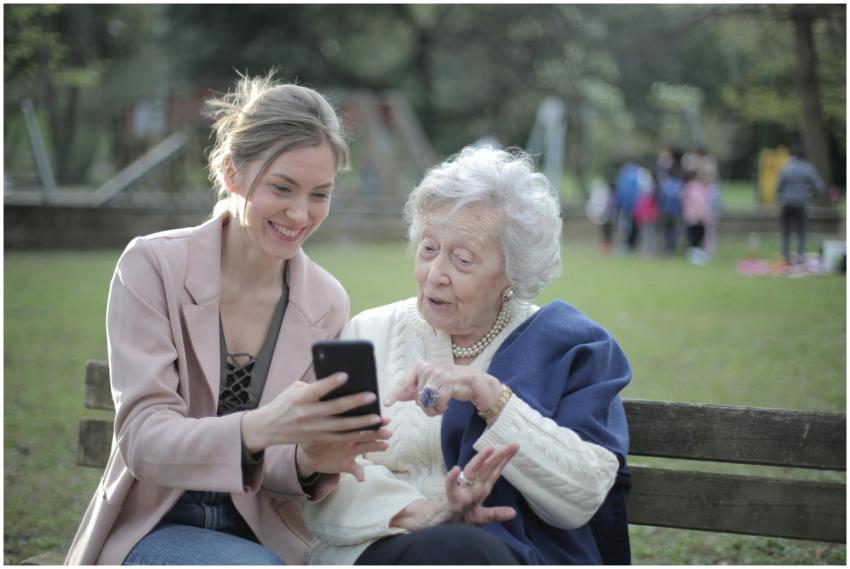 Delighted female relatives sitting together on woo