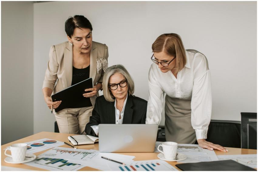 Three women in a business meeting, discussing stra
