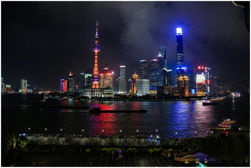 Illuminated Shanghai skyline with reflections on H