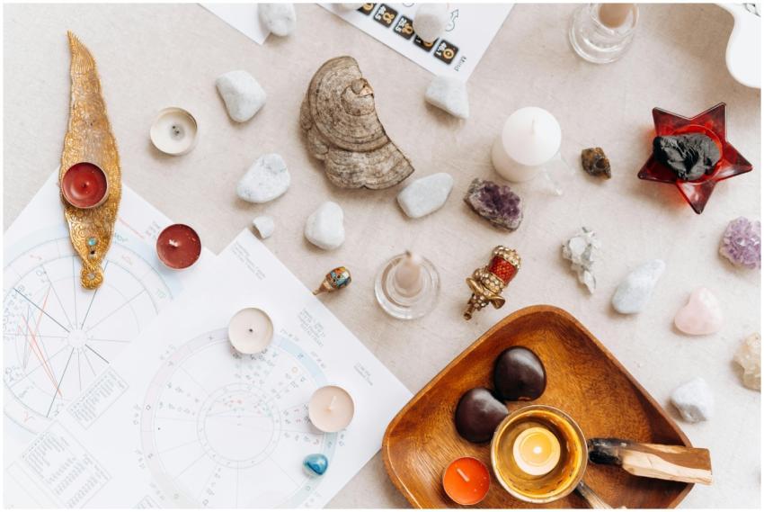 Flat lay of spiritual items including candles, cry