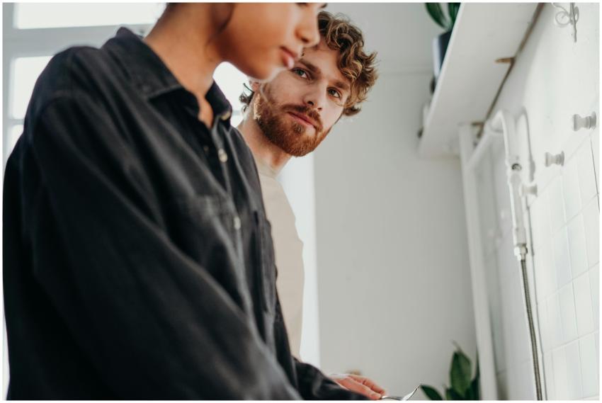 A young couple engaging in a modern kitchen settin