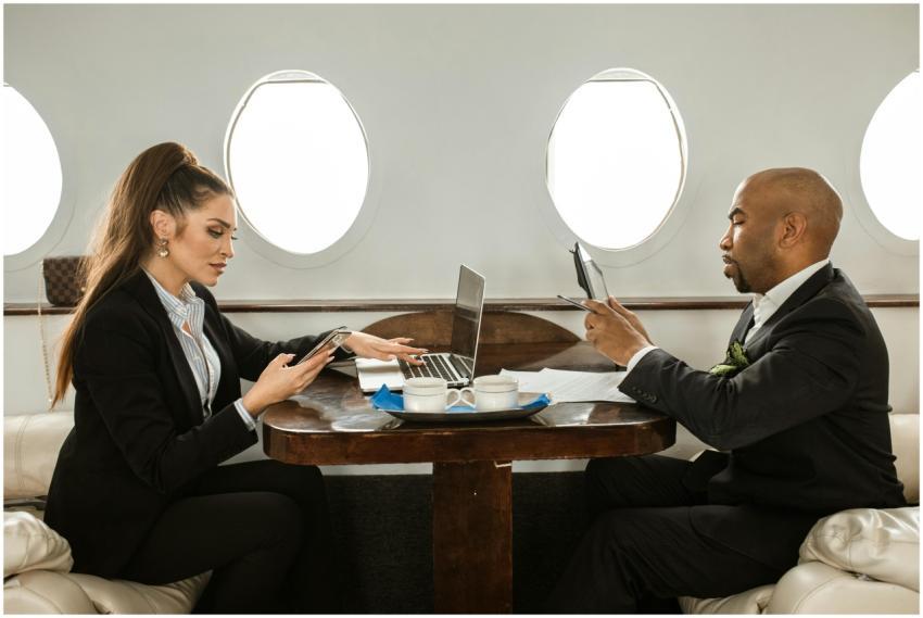 Two business professionals working on digital devi