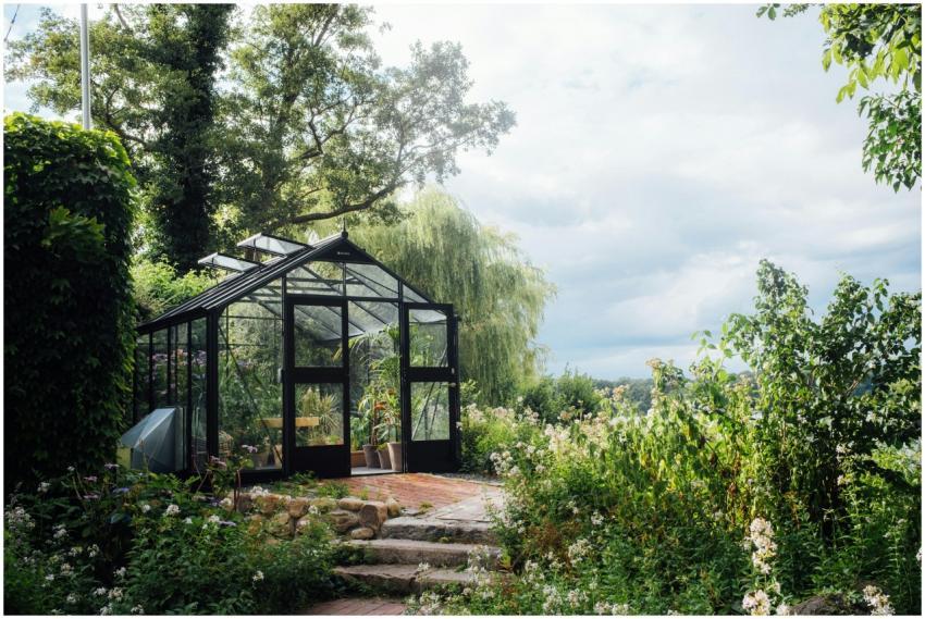 A picturesque greenhouse nestled in a vibrant gard