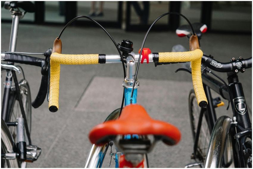 Vibrant yellow handlebars of a parked road bicycle