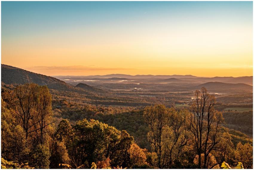 Breathtaking autumn sunrise over rolling hills and