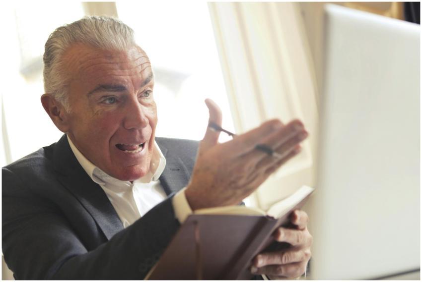 Elderly man engaged in a video conference, express