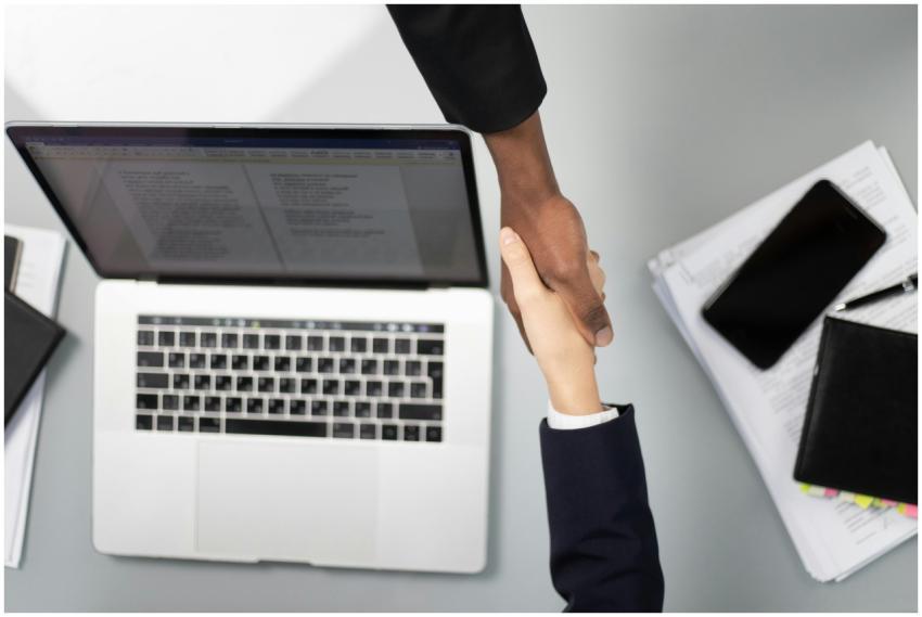 Overhead view of a professional handshake over a l