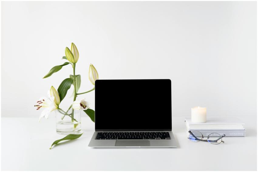 Elegant minimalist desk setup with laptop, white l