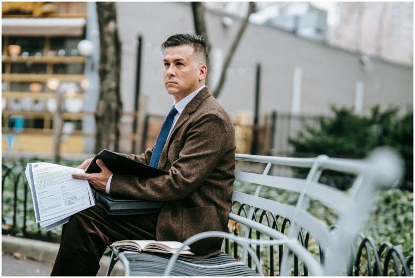 A professional man in formal wear reviewing docume