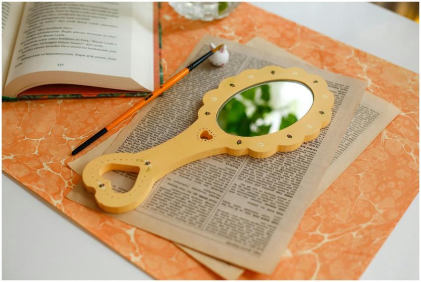 Elegant desk arrangement featuring a mirror, open