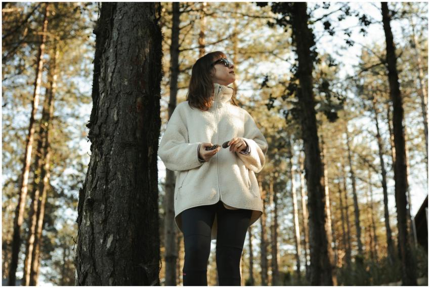 A woman enjoying a peaceful walk in the forest of
