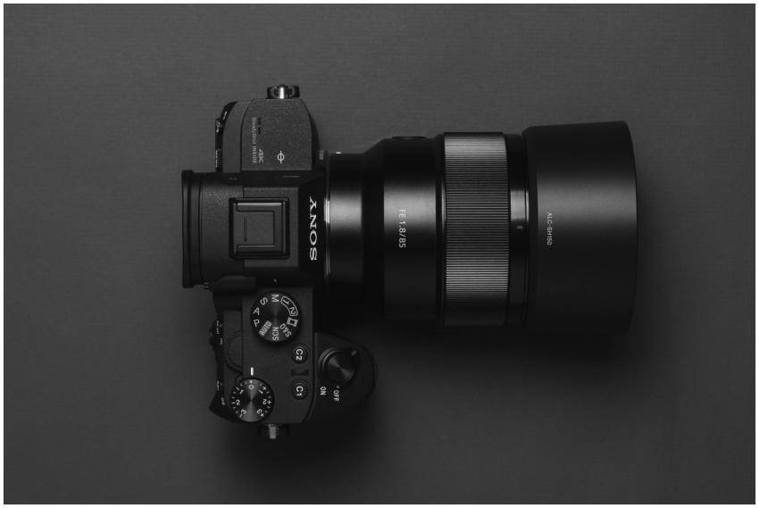 Top view of a sleek black DSLR camera with lens di