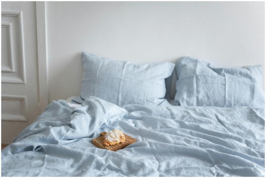 A tranquil bedroom scene featuring a croissant on