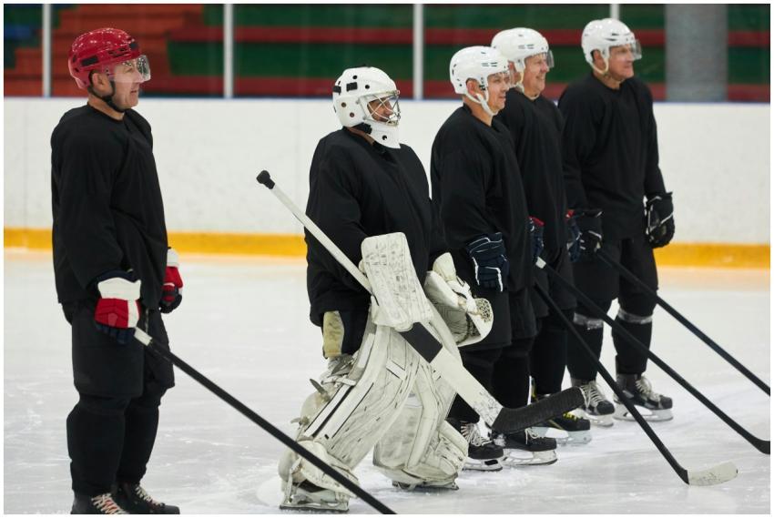 A team of adult male hockey players in uniforms st