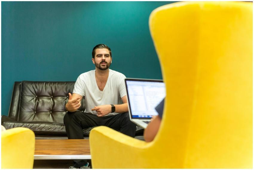 Casual office meeting with professionals discussin