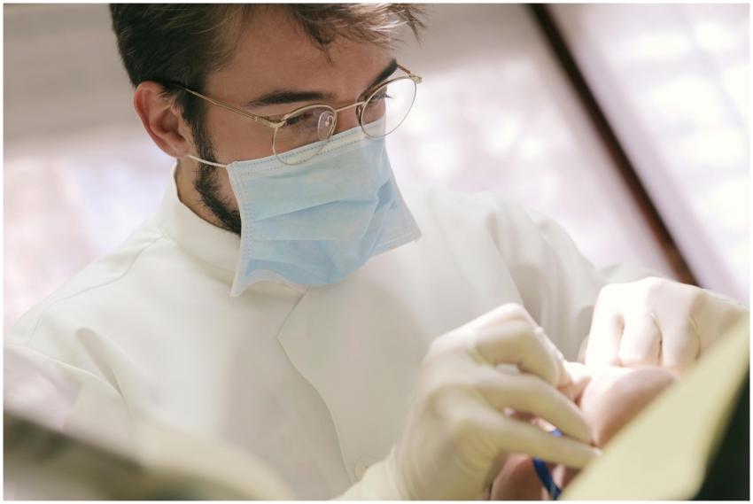 Close-up of dentist wearing face mask and gloves p