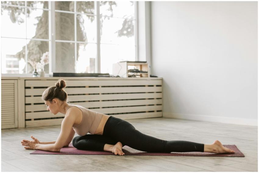 Woman in a yoga pose indoors, promoting healthy li