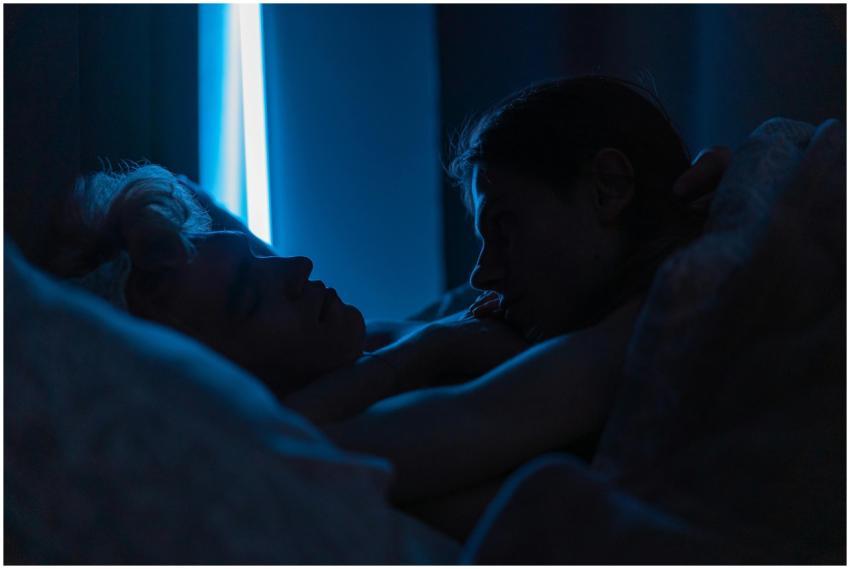 A romantic moment of two men sleeping closely toge