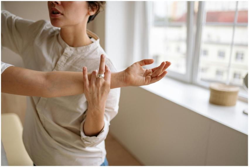 Physical therapist stretches a woman's arm in a su
