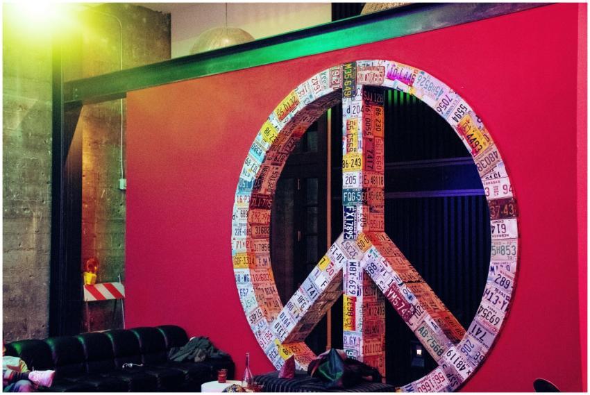 Vibrant peace sign made of license plates on a red