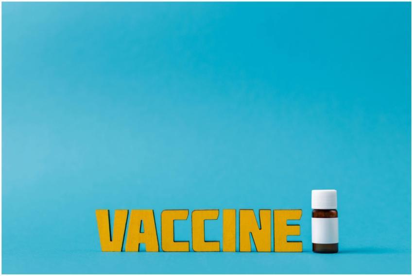 Yellow vaccine text with a bottle on a blue backgr