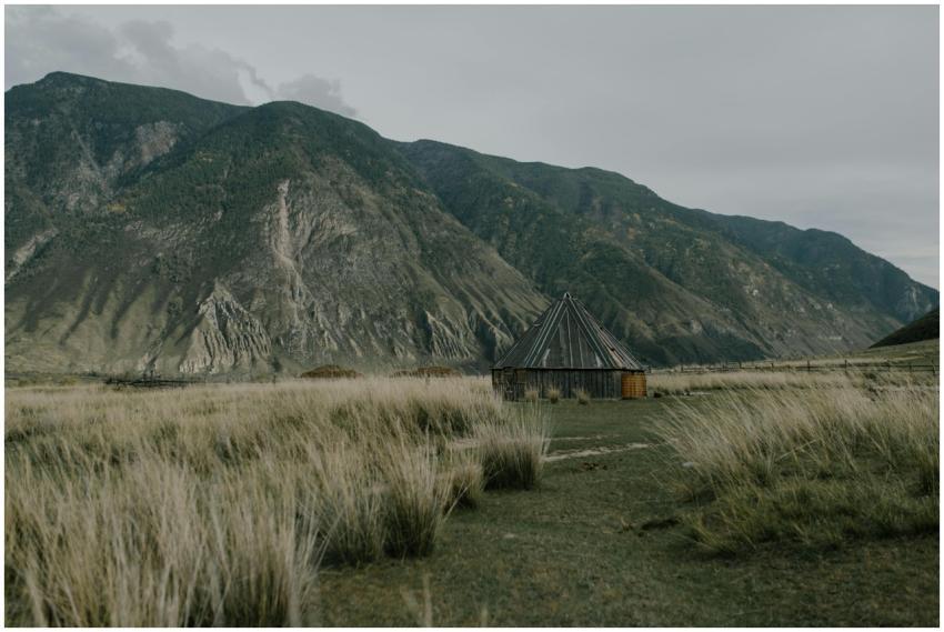 A wooden hut in a serene mountainous rural landsca