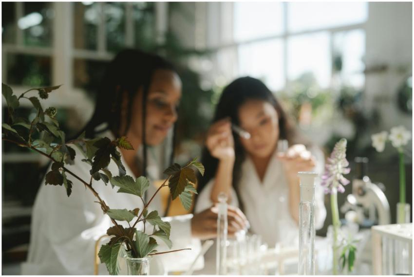 Two scientists working with plants in a bright lab