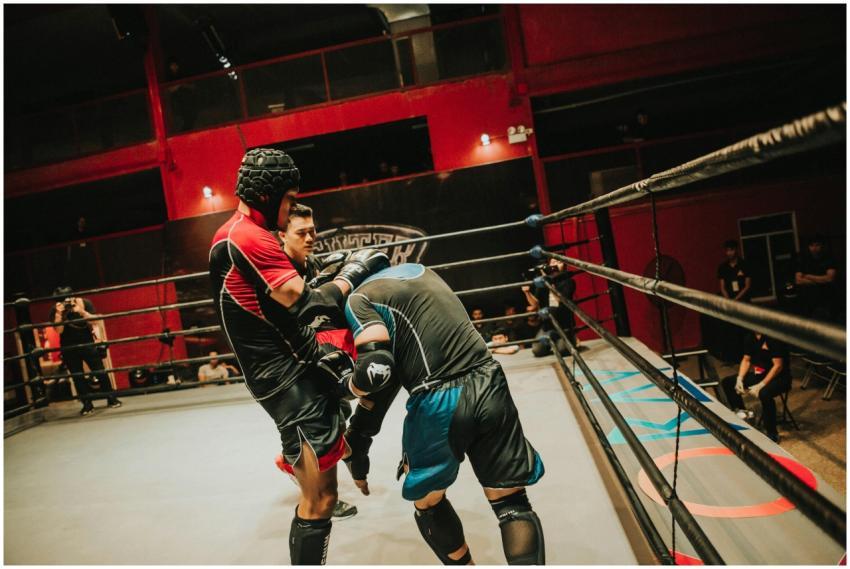 Two athletes compete in a fierce boxing match insi